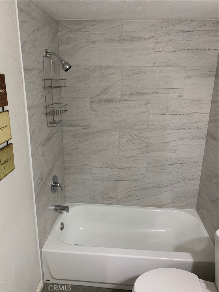 20415 Myron Street Perris, CA 92570 - Photo 18 of 29 a bathroom with a bathtub and a shower