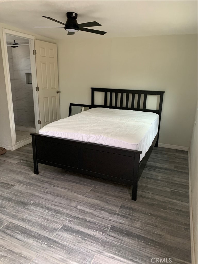 20415 Myron Street Perris, CA 92570 - Photo 27 of 29 a bedroom with a bed and wooden floor