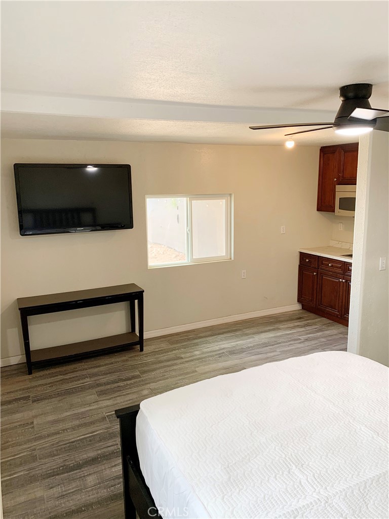 20415 Myron Street Perris, CA 92570 - Photo 28 of 29 a living room with a flat screen tv a lamp and a window