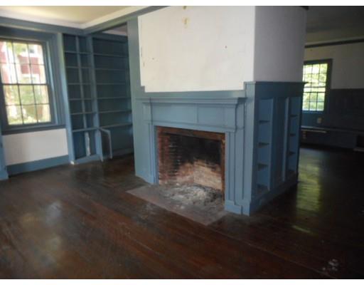 943 High Street Dedham, MA 02026 - Photo 3 of 25 a living room with a fireplace and a wooden floor