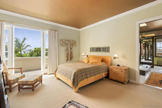 a bedroom with a bed and a painting on the wall