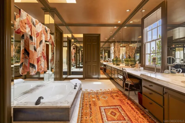 a large kitchen with stainless steel appliances granite countertop a large sink and a stove