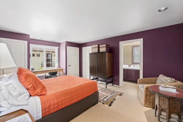 a bedroom with bed and glass window