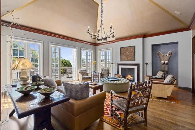 a living room with fireplace furniture and a chandelier
