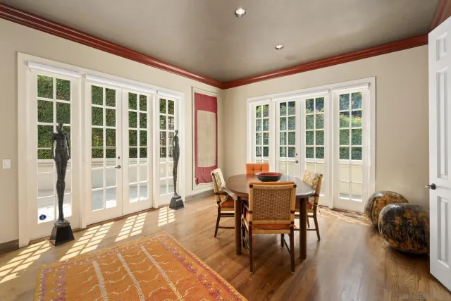 a dining room with furniture and wooden floor