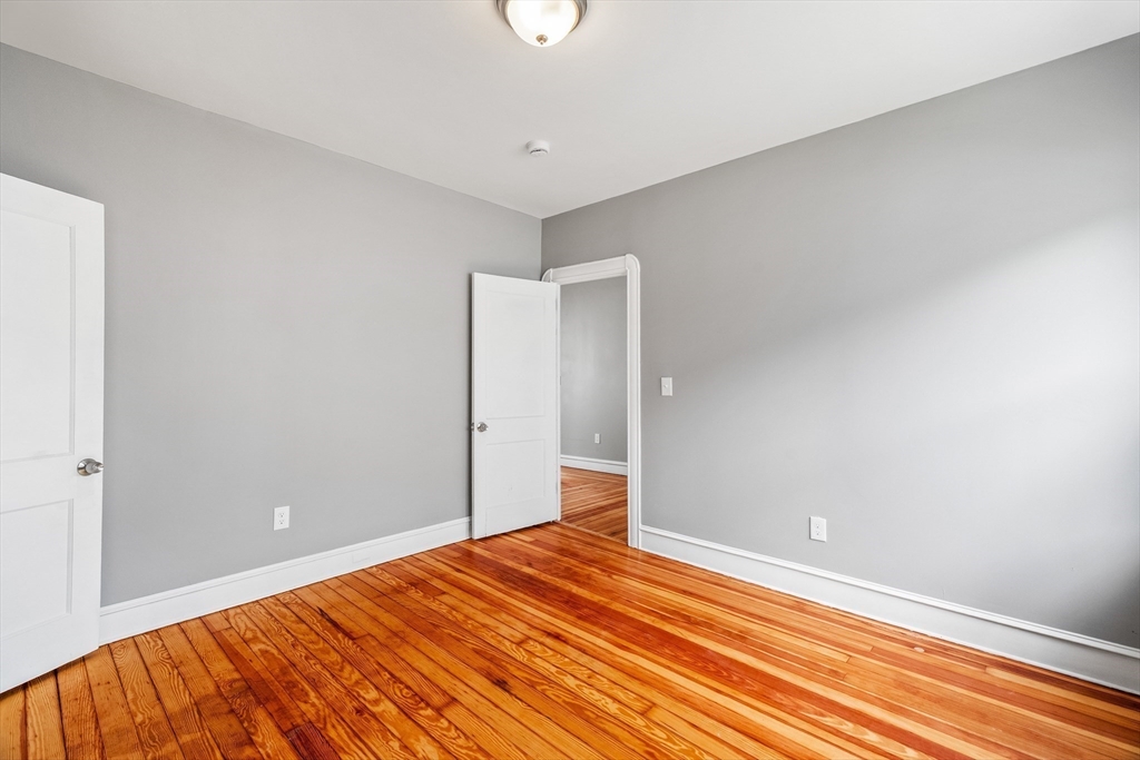 100 Weetamoe Street Fall River, MA 02720 - Photo 12 of 42 a view of empty room with wooden floor