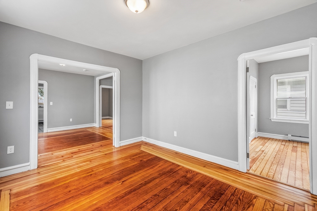 100 Weetamoe Street Fall River, MA 02720 - Photo 14 of 42 wooden floor in an empty room with a window