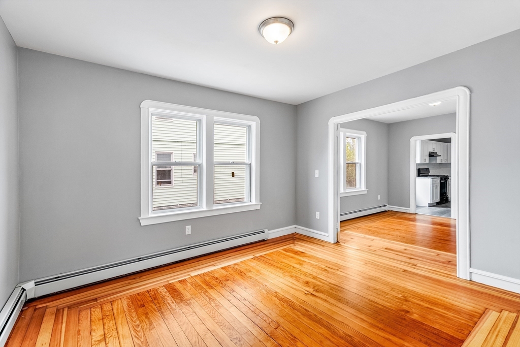 100 Weetamoe Street Fall River, MA 02720 - Photo 15 of 42 an empty room with wooden floor and windows