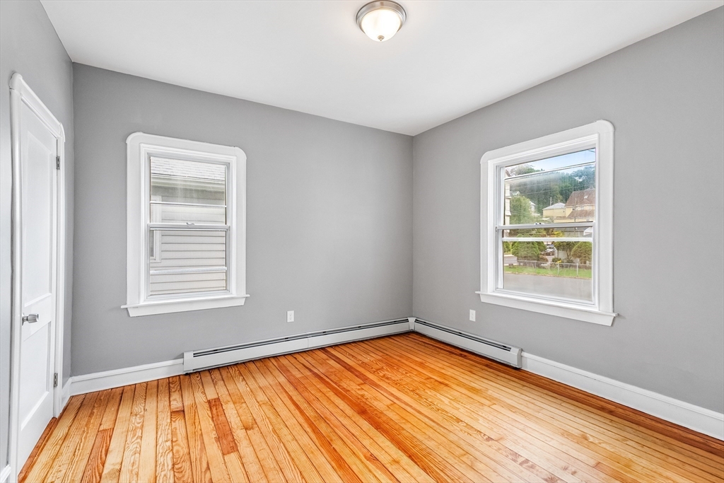 100 Weetamoe Street Fall River, MA 02720 - Photo 16 of 42 a view of an empty room with wooden floor and a window