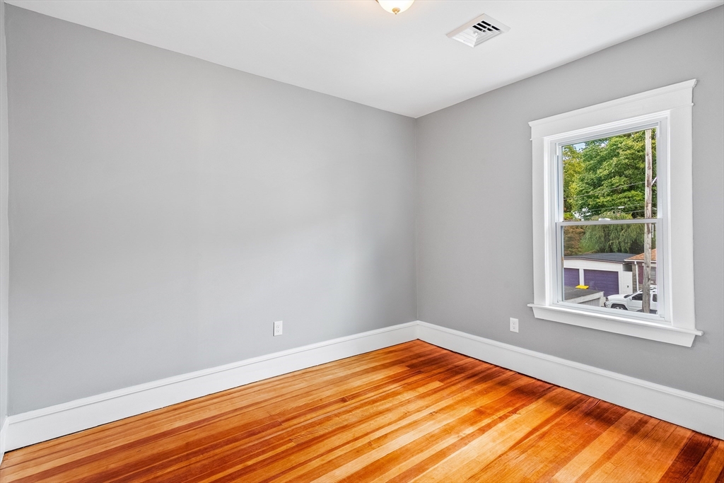 100 Weetamoe Street Fall River, MA 02720 - Photo 18 of 42 a view of an empty room with wooden floor and a window