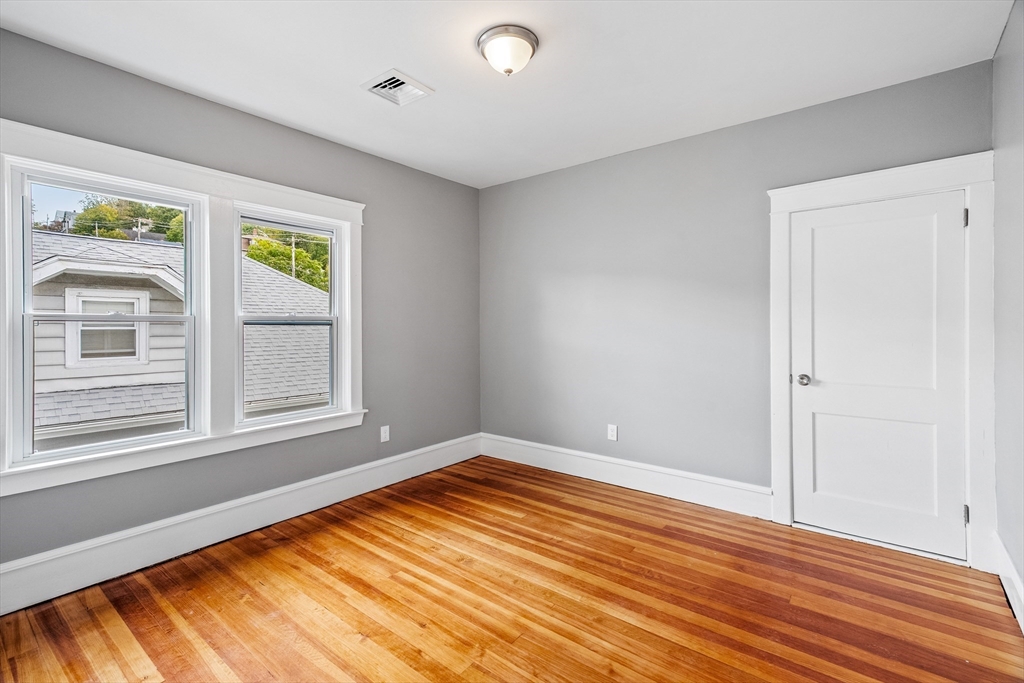 100 Weetamoe Street Fall River, MA 02720 - Photo 20 of 42 a view of empty room with wooden floor and fan