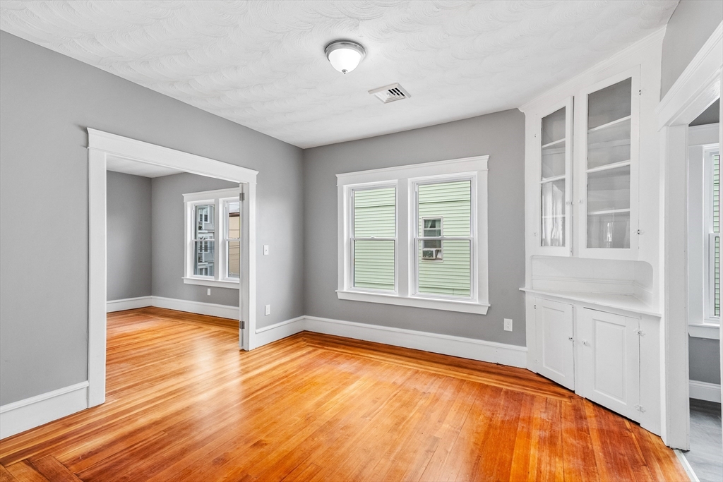 100 Weetamoe Street Fall River, MA 02720 - Photo 23 of 42 an empty room with wooden floor and windows