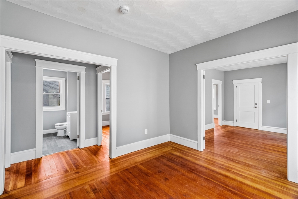 100 Weetamoe Street Fall River, MA 02720 - Photo 24 of 42 a view of a room with wooden floor and a bathroom