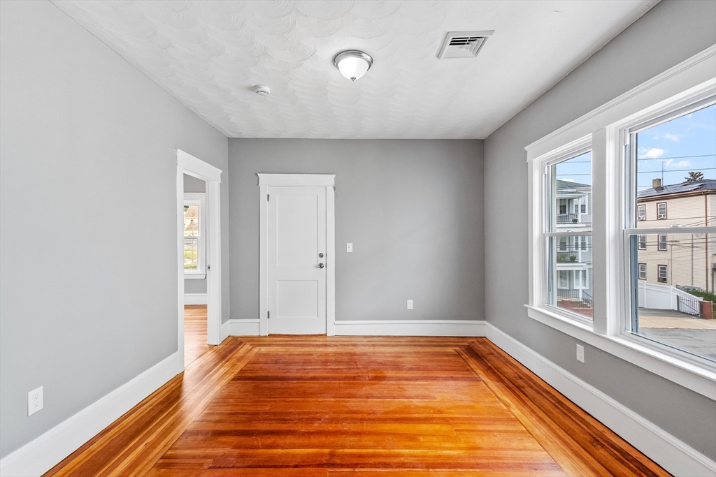 100 Weetamoe Street Fall River, MA 02720 - Photo 25 of 42 a view of room with window and wooden floor