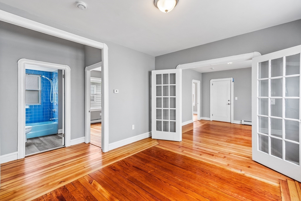 100 Weetamoe Street Fall River, MA 02720 - Photo 26 of 42 an empty room with wooden floor and windows