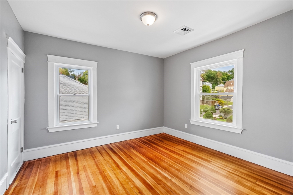 100 Weetamoe Street Fall River, MA 02720 - Photo 27 of 42 a view of an empty room with wooden floor and a window