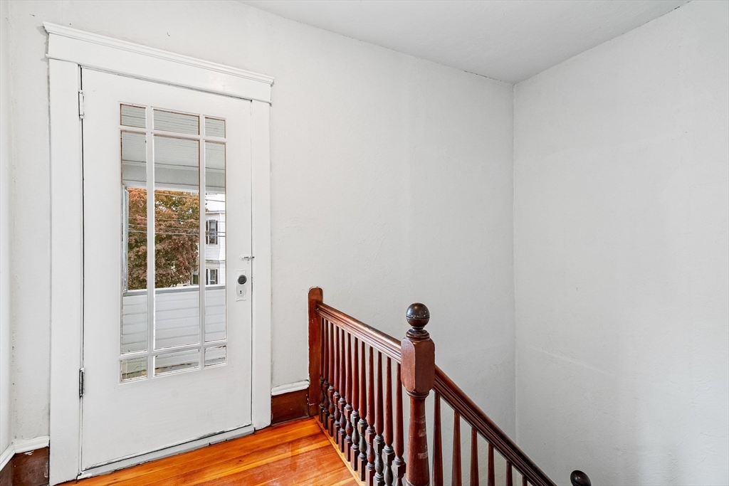 100 Weetamoe Street Fall River, MA 02720 - Photo 29 of 42 a view of a hallway with wooden floor and a window