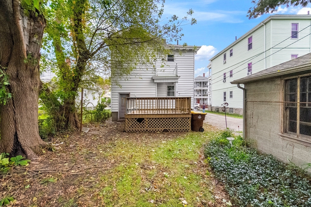 100 Weetamoe Street Fall River, MA 02720 - Photo 35 of 42 a view of backyard with a garden and deck