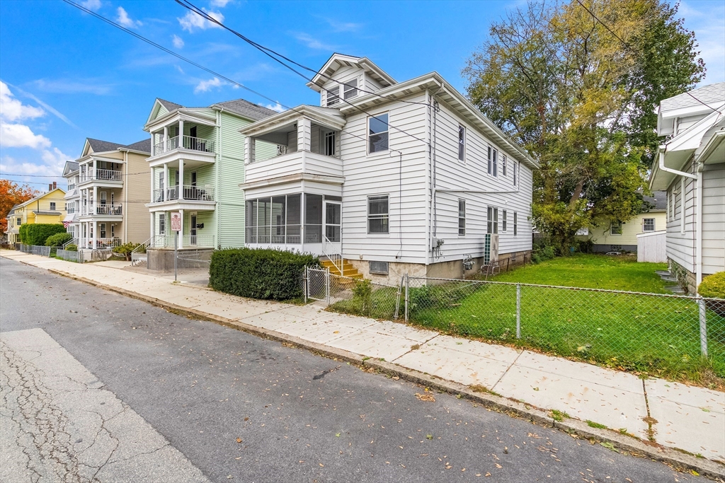 100 Weetamoe Street Fall River, MA 02720 - Photo 40 of 42 a front view of a house with a yard