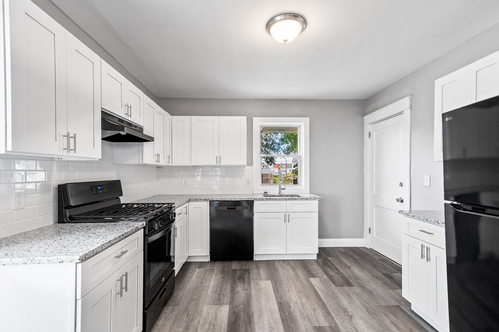 100 Weetamoe Street Fall River, MA 02720 - Photo 4 of 42 a kitchen with a sink stove and refrigerator