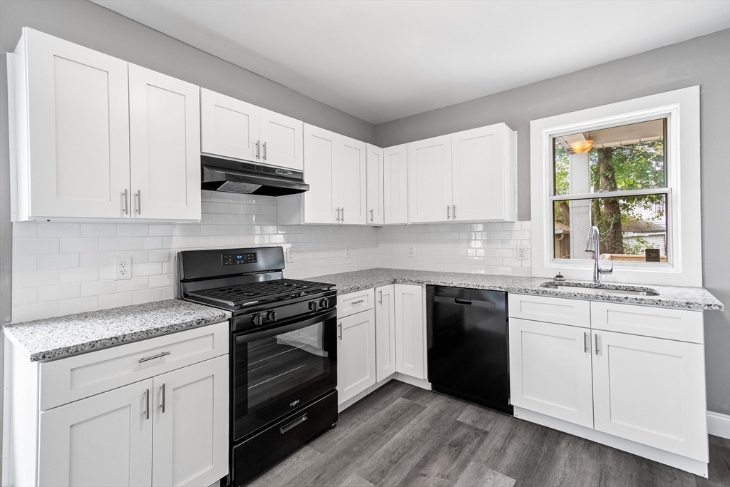 100 Weetamoe Street Fall River, MA 02720 - Photo 6 of 42 a kitchen with granite countertop white cabinets and appliances