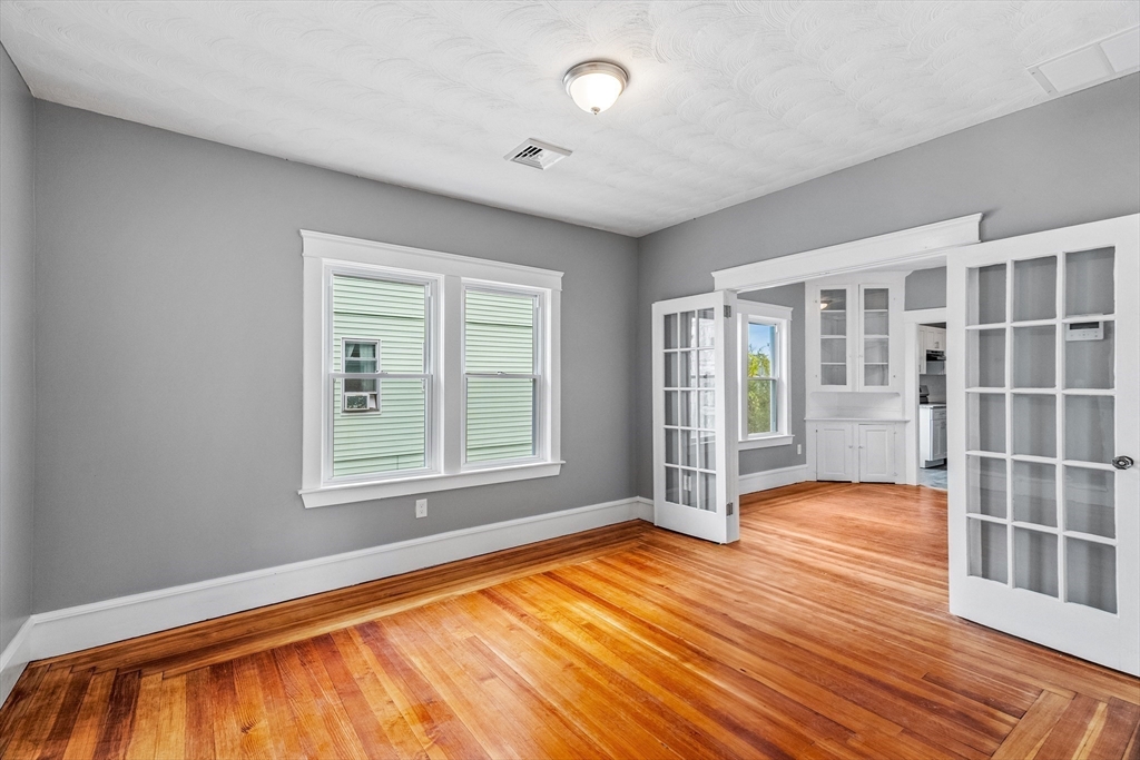 100 Weetamoe Street Fall River, MA 02720 - Photo 7 of 42 a view of an empty room with wooden floor and a window