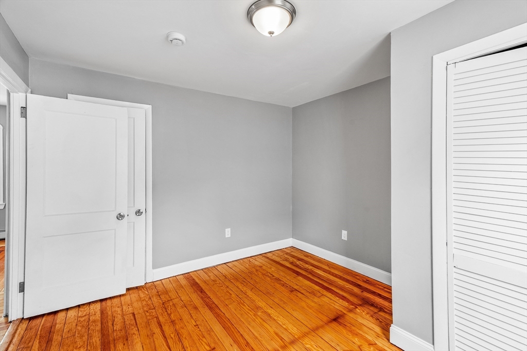 100 Weetamoe Street Fall River, MA 02720 - Photo 9 of 42 a view of empty room with wooden floor