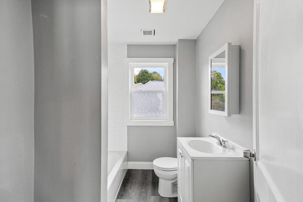 100 Weetamoe Street Fall River, MA 02720 - Photo 10 of 42 a bathroom with a toilet a sink and a window