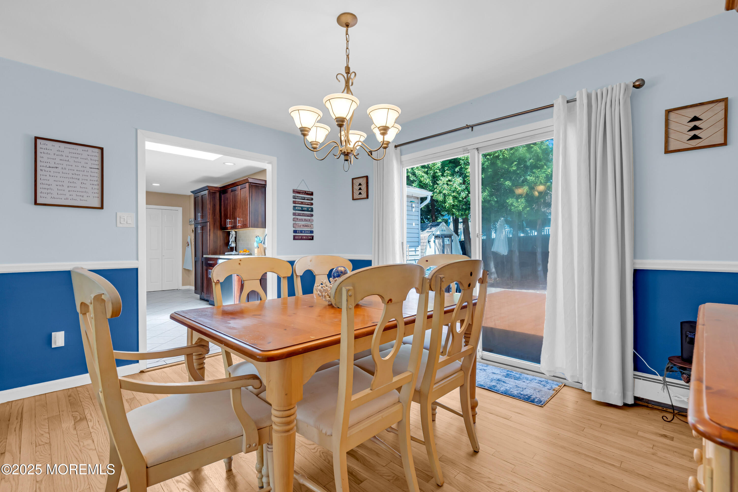 810 Devon Street Forked River, NJ 08731 - Photo 17 of 43 a dining room with furniture a large window and wooden floor