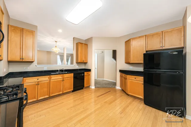 a kitchen with stainless steel appliances granite countertop a refrigerator and a sink