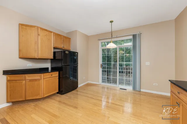 a kitchen with stainless steel appliances granite countertop a refrigerator sink and cabinets