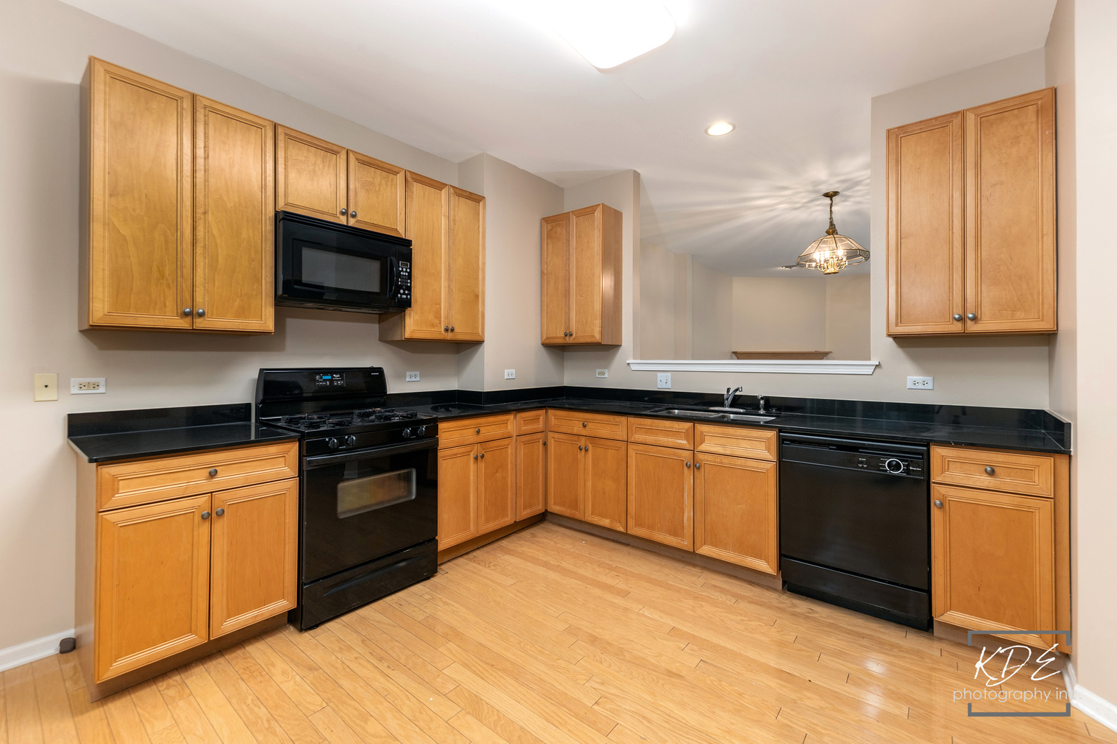 S044 Lee Court Winfield, IL 60190 - Photo 4 of 25 a kitchen with stainless steel appliances granite countertop a stove a sink and a microwave