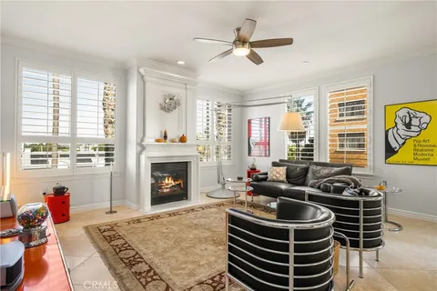 a living room with furniture a fireplace and a large window
