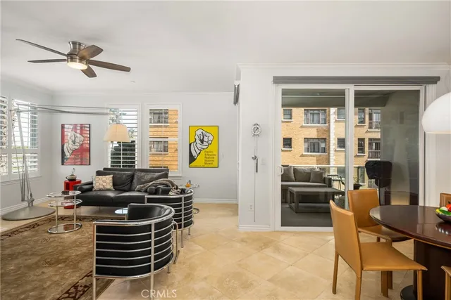 a kitchen with stainless steel appliances a refrigerator a stove a sink dishwasher and a dining table with wooden floor