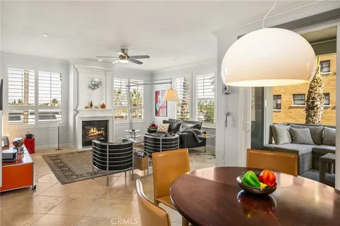 a kitchen with stainless steel appliances granite countertop a stove a sink a refrigerator white and white cabinets and wooden floor