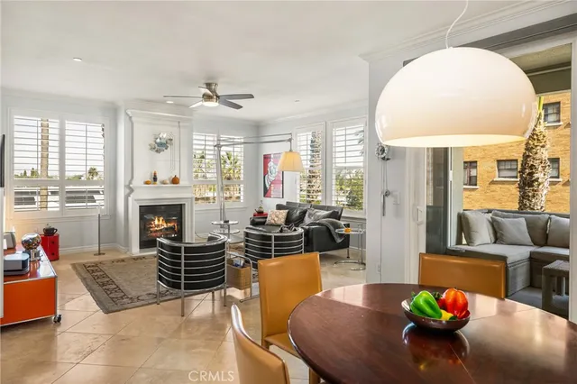 a kitchen with stainless steel appliances granite countertop a stove a sink a refrigerator white and white cabinets and wooden floor