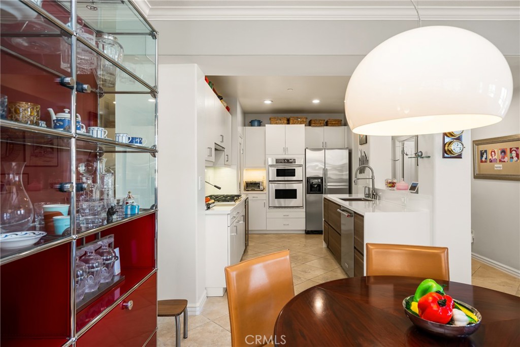 1000 East Ocean Boulevard, Unit 613 Long Beach, CA 90802 - Photo 20 of 65 a kitchen with stainless steel appliances granite countertop a sink refrigerator and cabinets