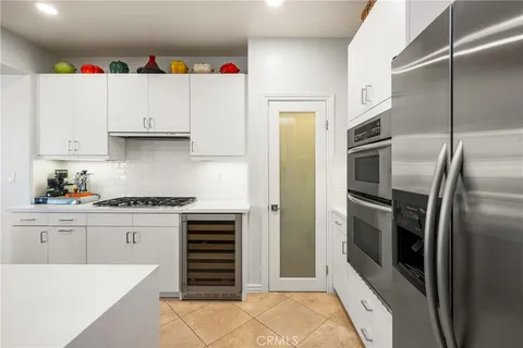 a bathroom with a granite countertop tub sink and mirror