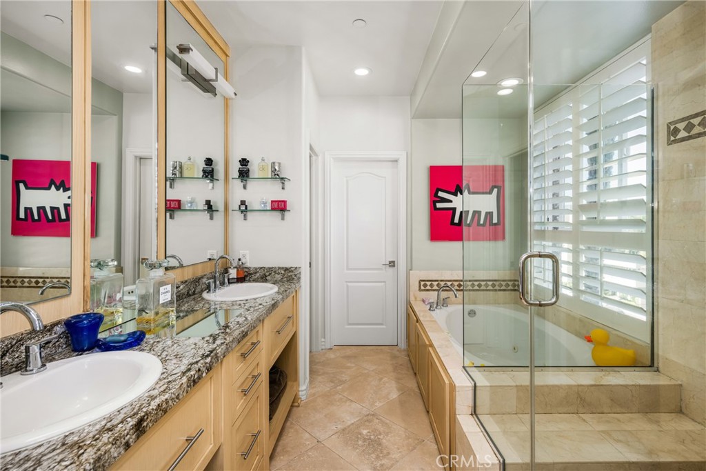 1000 East Ocean Boulevard, Unit 613 Long Beach, CA 90802 - Photo 34 of 65 a bathroom with a granite countertop tub sink and mirror