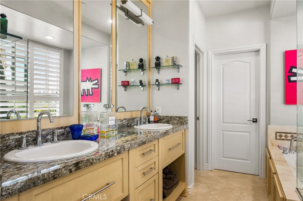 1000 East Ocean Boulevard, Unit 613 Long Beach, CA 90802 - Photo 35 of 65 a bathroom with a granite countertop double vanity and a sink