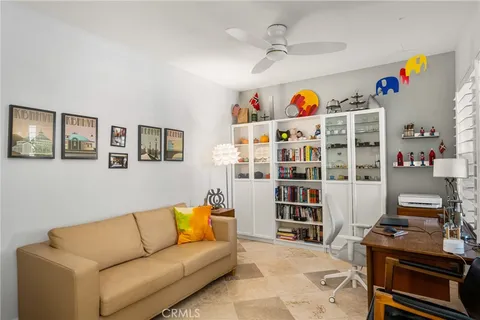 a living room with a dining table wooden floor and a fireplace