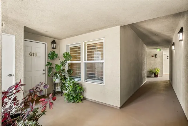 a living room with fireplace furniture and a large window