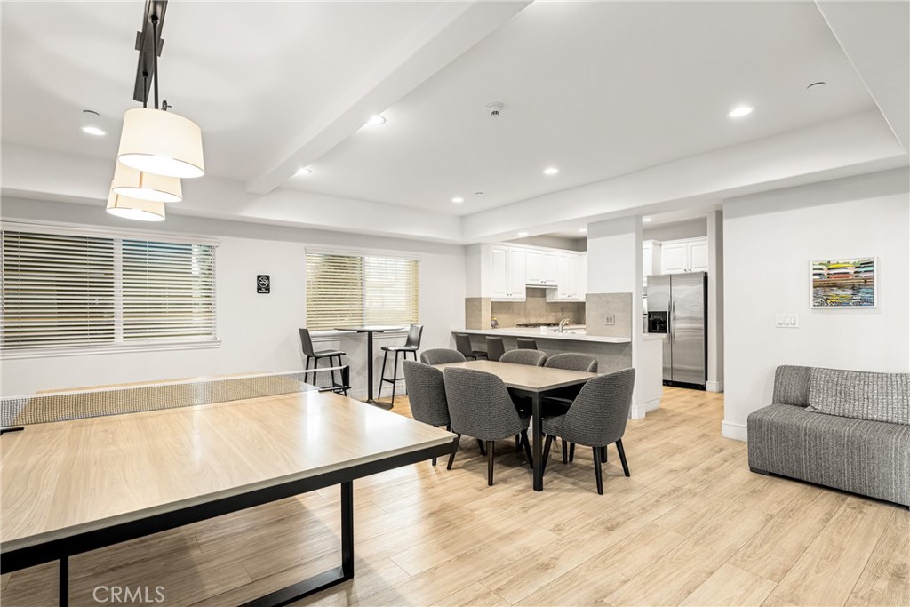 1000 East Ocean Boulevard, Unit 613 Long Beach, CA 90802 - Photo 51 of 65 a living room with a dining table wooden floor and a fireplace