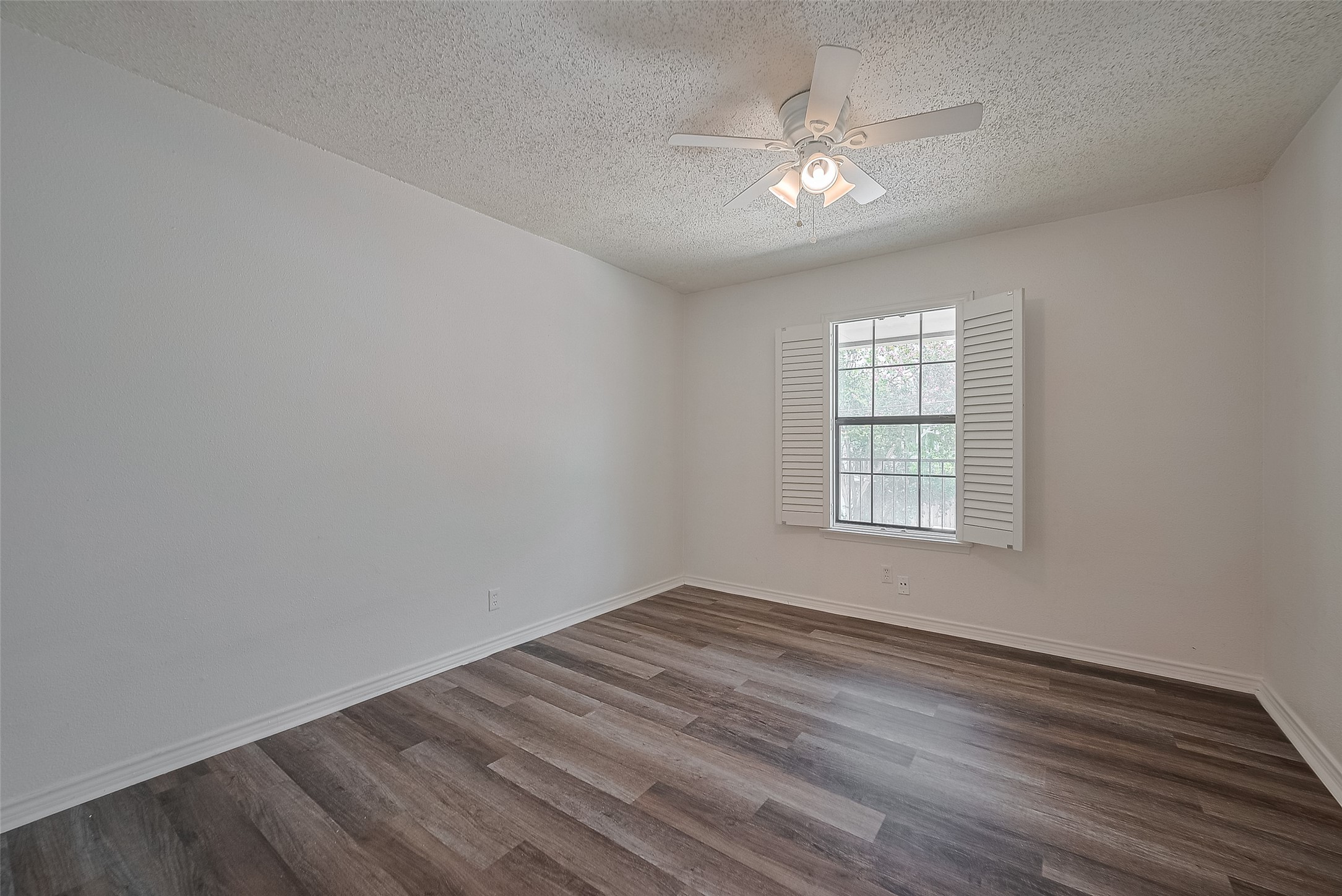 606 Marshall Street, Unit 35 Houston, TX 77006 - Photo 6 of 13 wooden floor in an empty room with a window