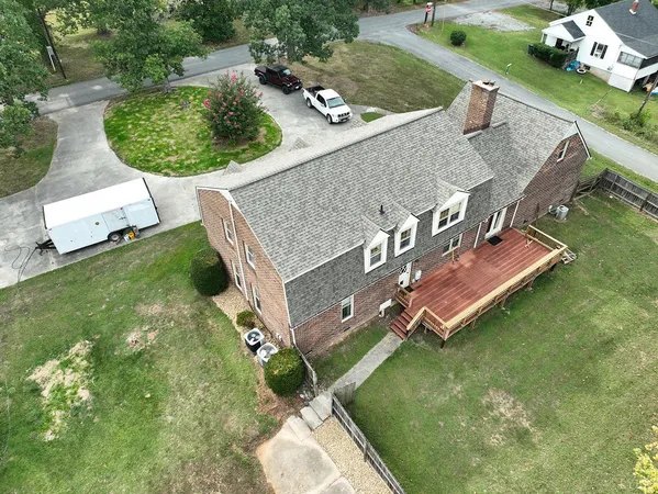 an aerial view of a house with a garden and swimming pool