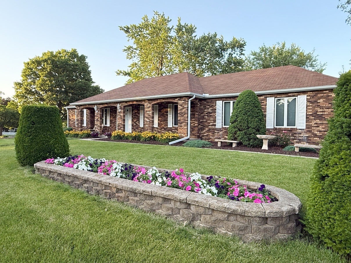 300 Fieldstone Lane Dixon, IL 61021 - Photo 34 of 34 a front view of a house with a big yard and potted plants