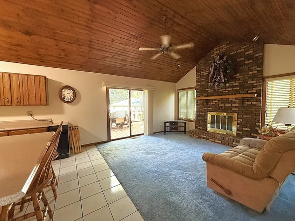a living room with hard wood floors and a kitchen