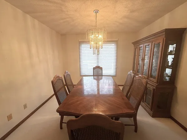 a view of a dining room with furniture window and outside view