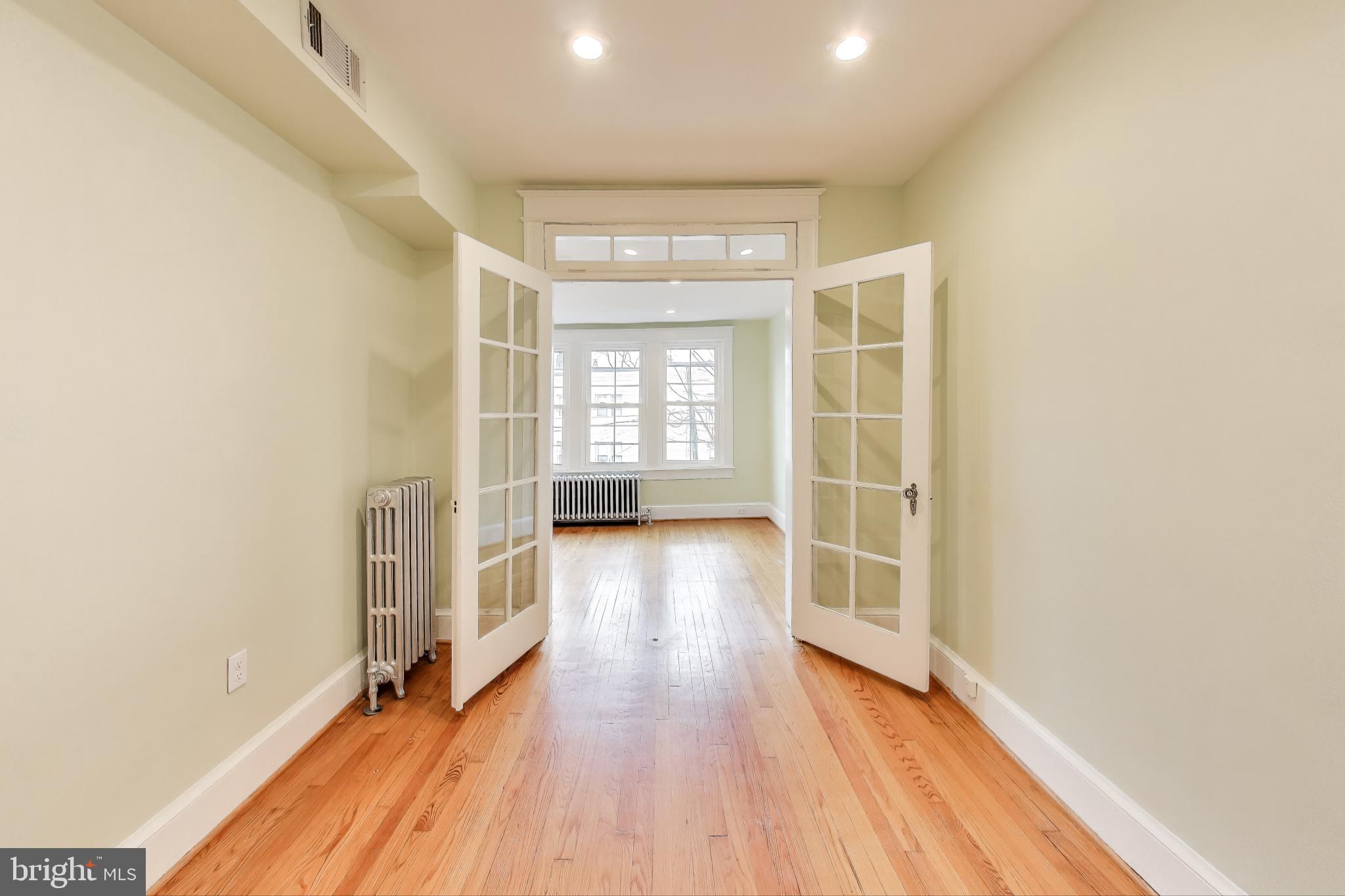 628 Madison Street Northwest Washington, DC 20011 - Photo 18 of 47 wooden floor in an empty room with a window