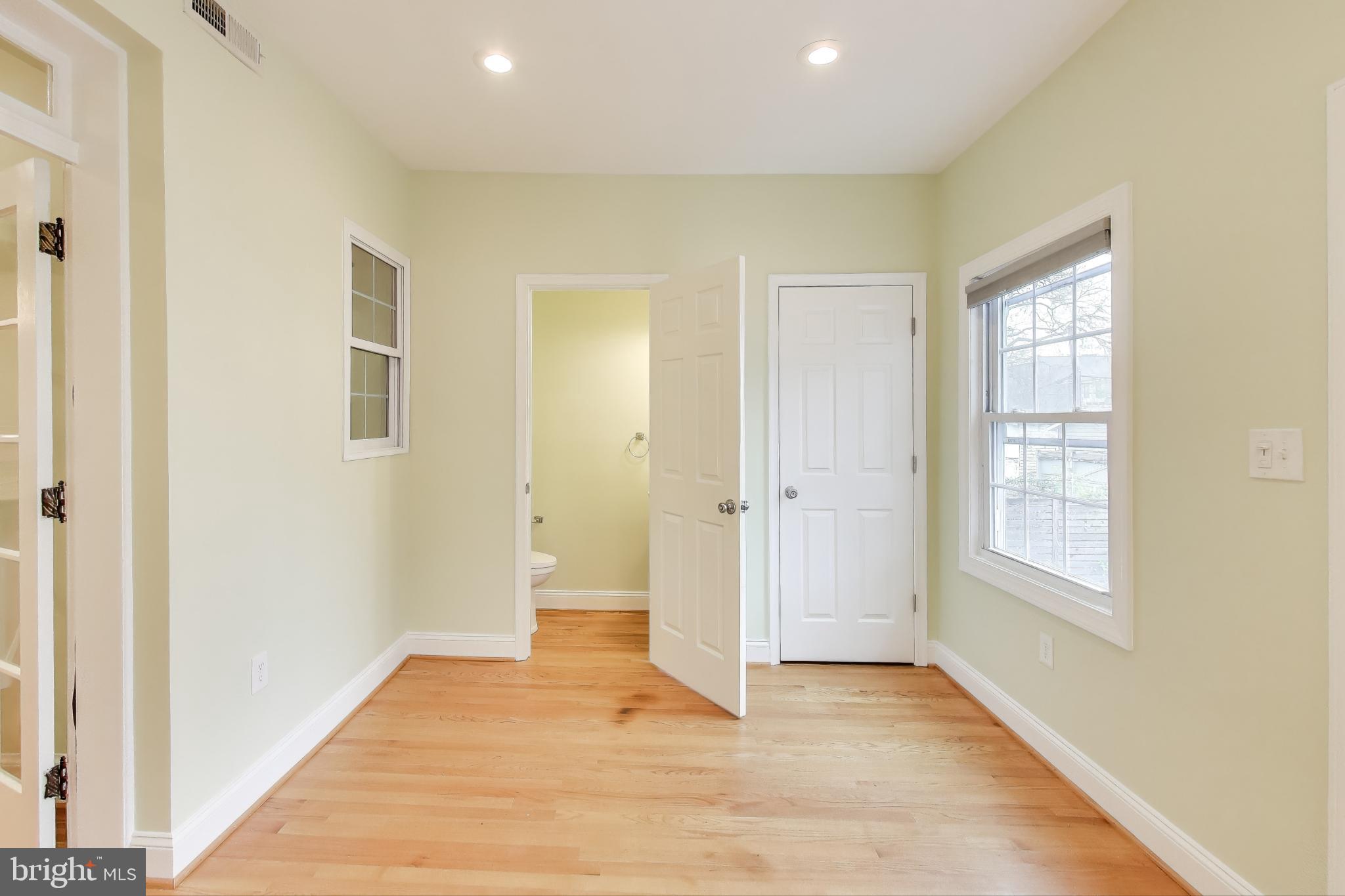 628 Madison Street Northwest Washington, DC 20011 - Photo 28 of 47 a view of an empty room with wooden floor and a window